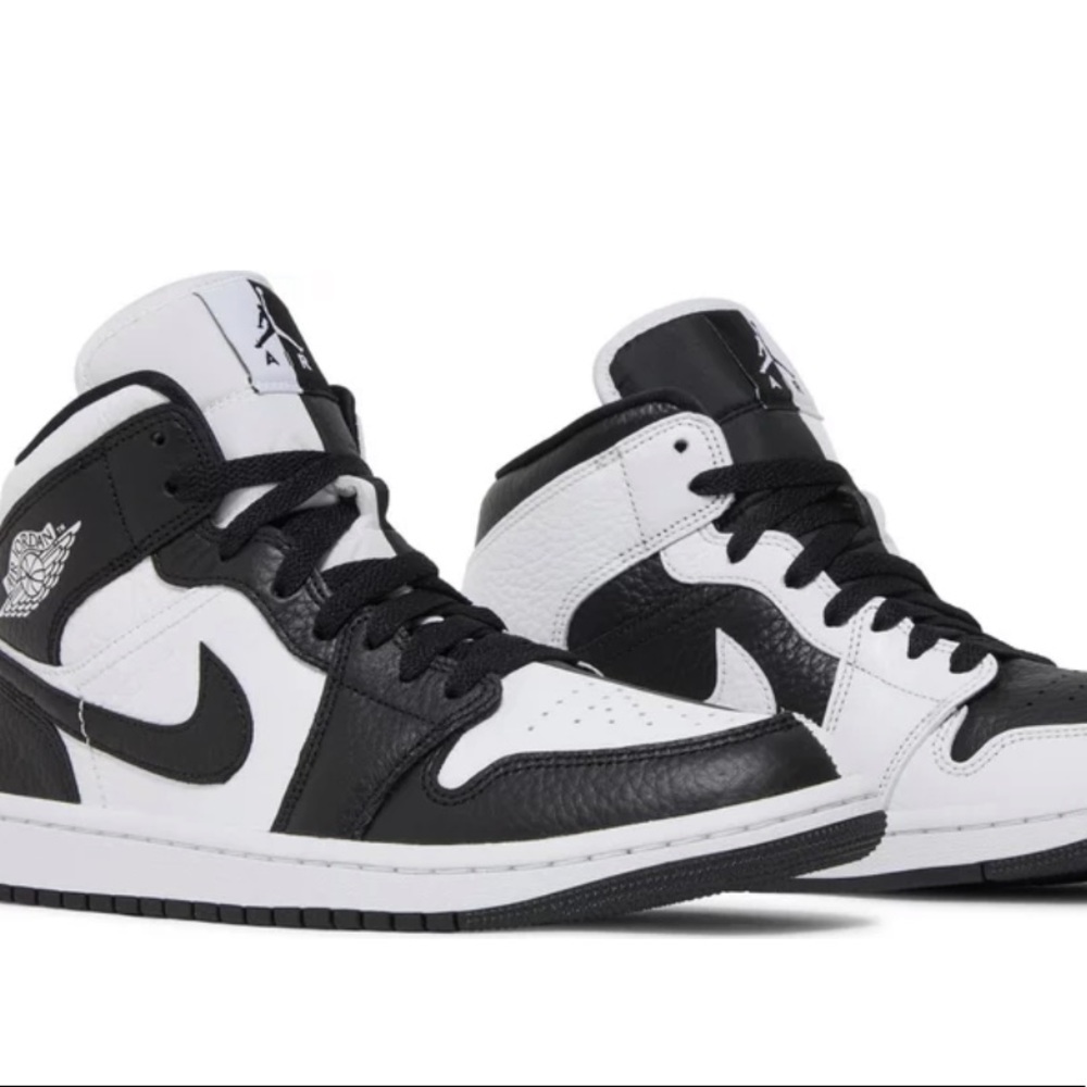 Black and white Nike Jordan 1 mids